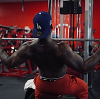 a man doing a squat in a gym